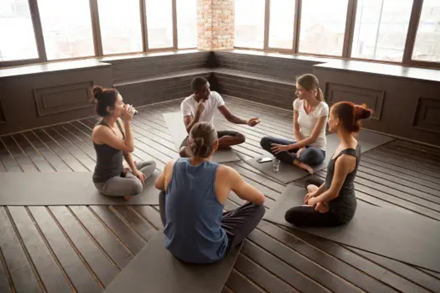 Group of Brain Fitness Coaches sitting in circle